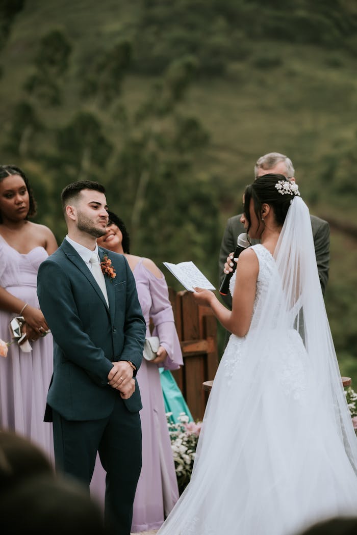The Art of Drawing Readers In: Your attractive post title goes here Bride and groom exchanging vows at outdoor wedding ceremony, surrounded by bridesmaids.